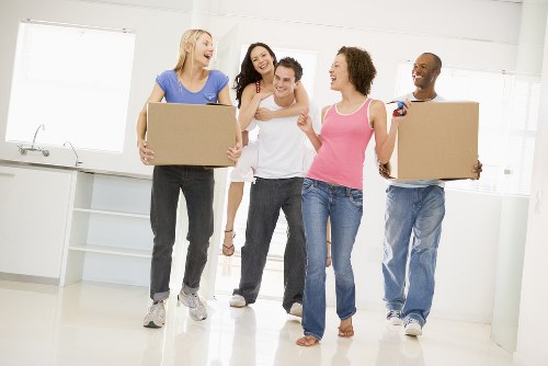 Movers loading household items into a transport van