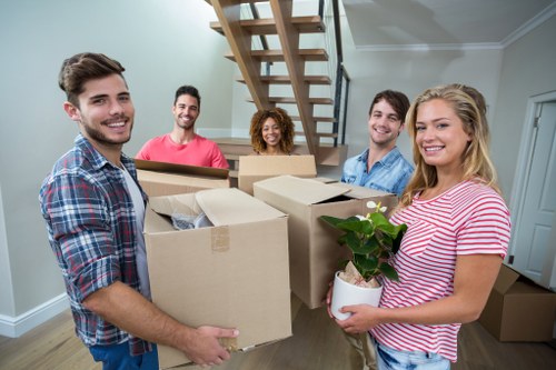 Student removal team helping with boxes outside a Battersea property