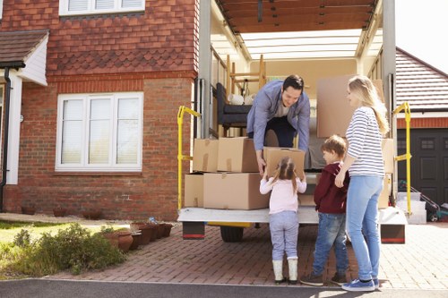 Battersea Movers pricing overview with moving boxes and a van